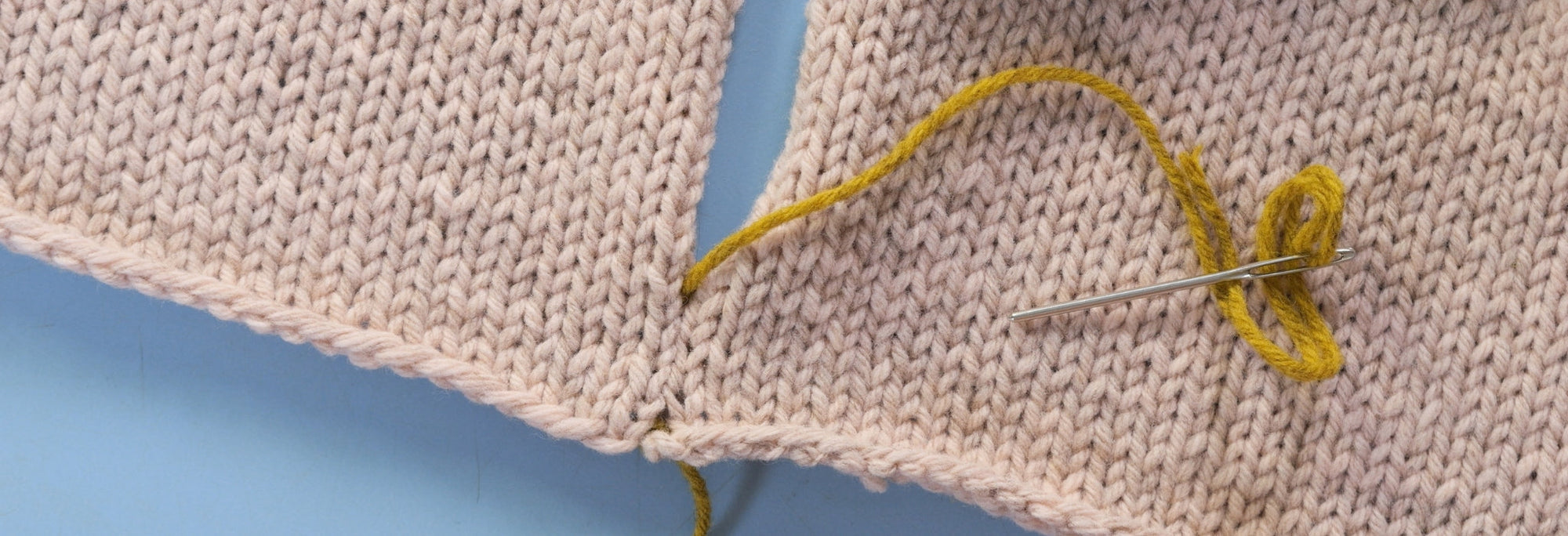 The beginning of a mattress stitch in contrasting yarn
